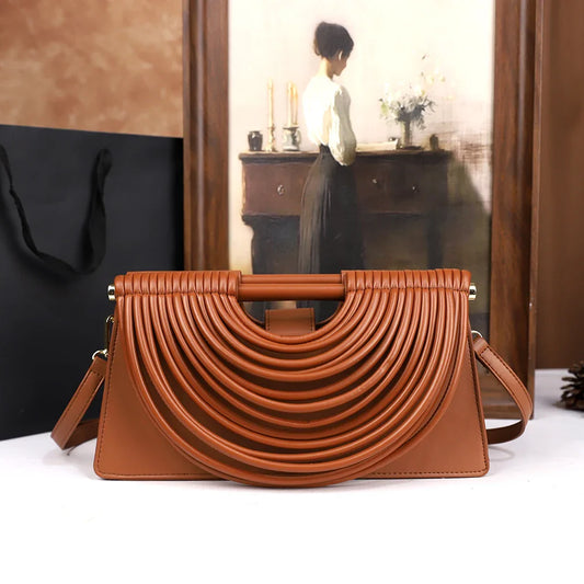 The 2025 new hand-held woven bag with lines is a unique, high-end, individual and fashionable handbag for women