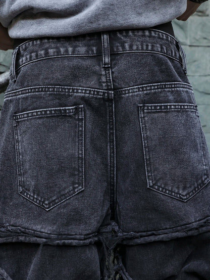 Men's black jeans. With a design of (ripped holes) and tassels. In a street trend style.