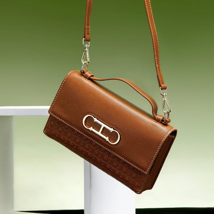 Premium Leather Handbag Monogram Embossing Metallic Clasp Portable Handle Structured Silhouette Ideal Office Evening Events